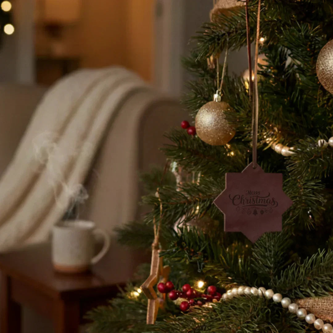 Decorated Christmas tree with a 'Merry Christmas' tag in a cozy living room setting.