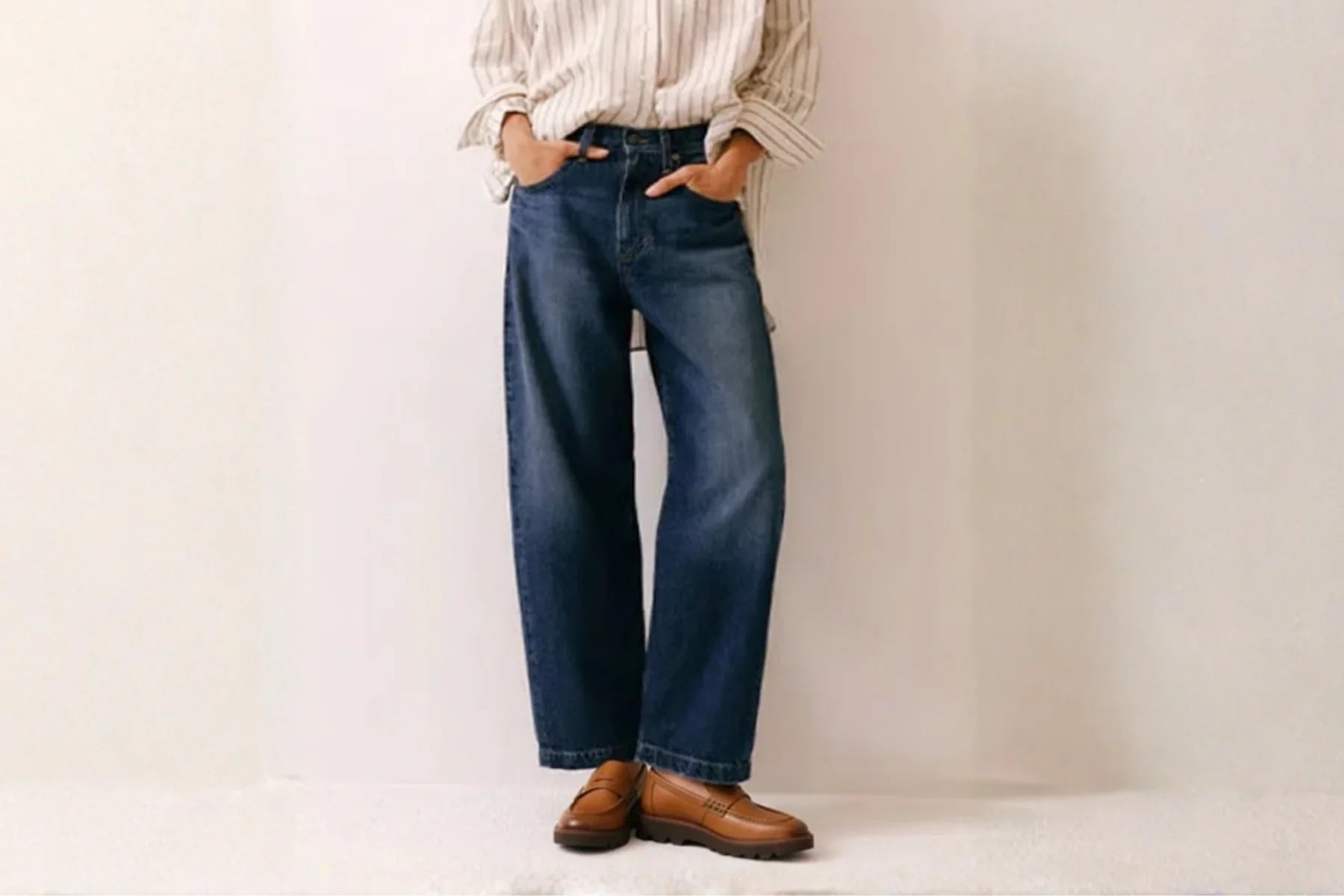 Brown leather loafers with chunky sole styled with blue jeans and striped shirt