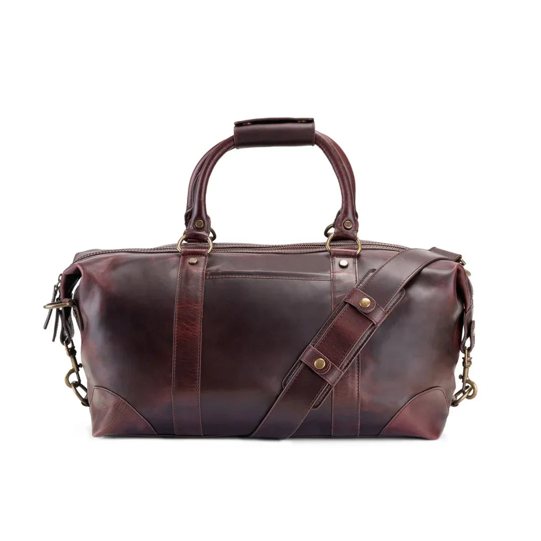 Brown leather duffel bag with gold accents