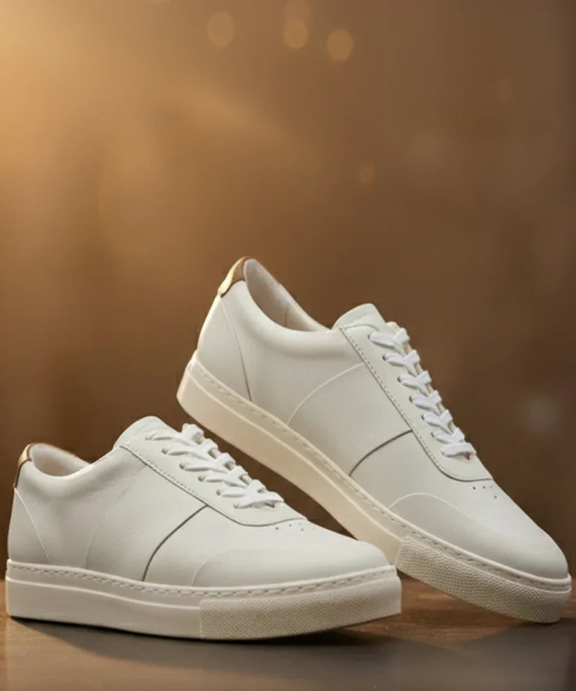 Women's white leather sneakers with laces on a brown background, minimalist style