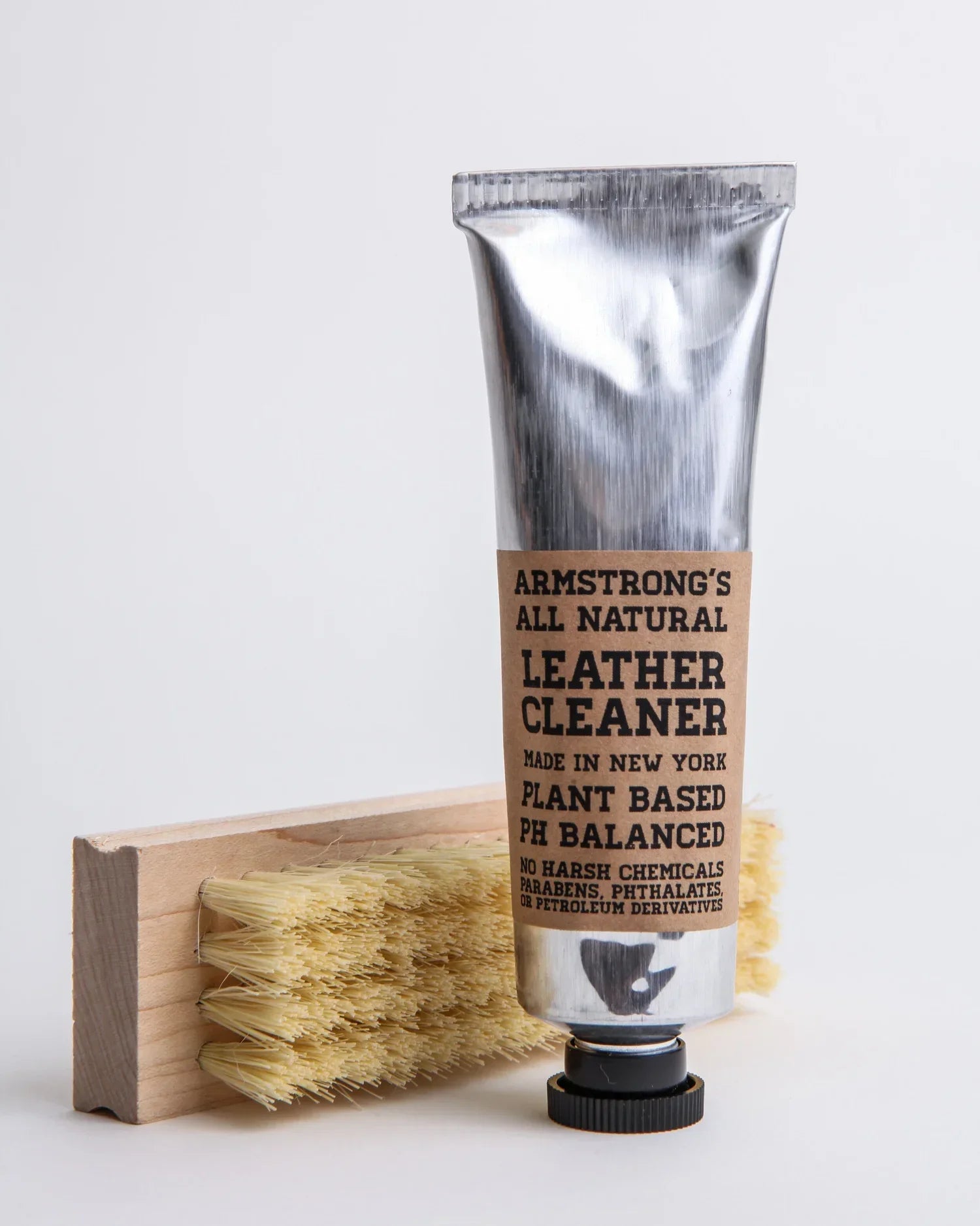 Armstrong's all natural leather cleaner with a brush on a white background