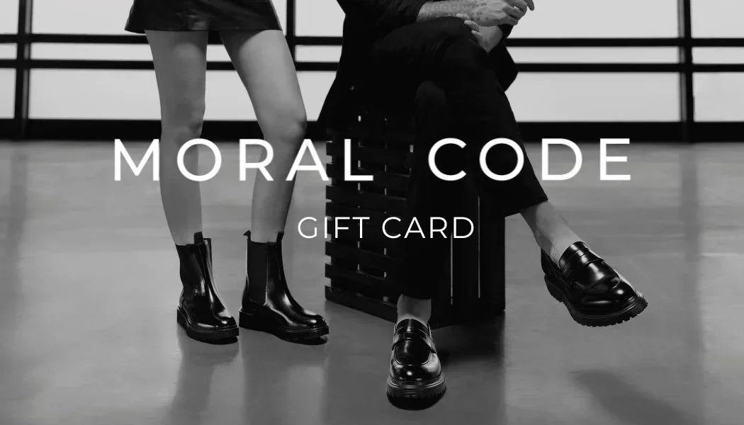 Two people sitting on a bench with 'Moral Code' gift card text overlay