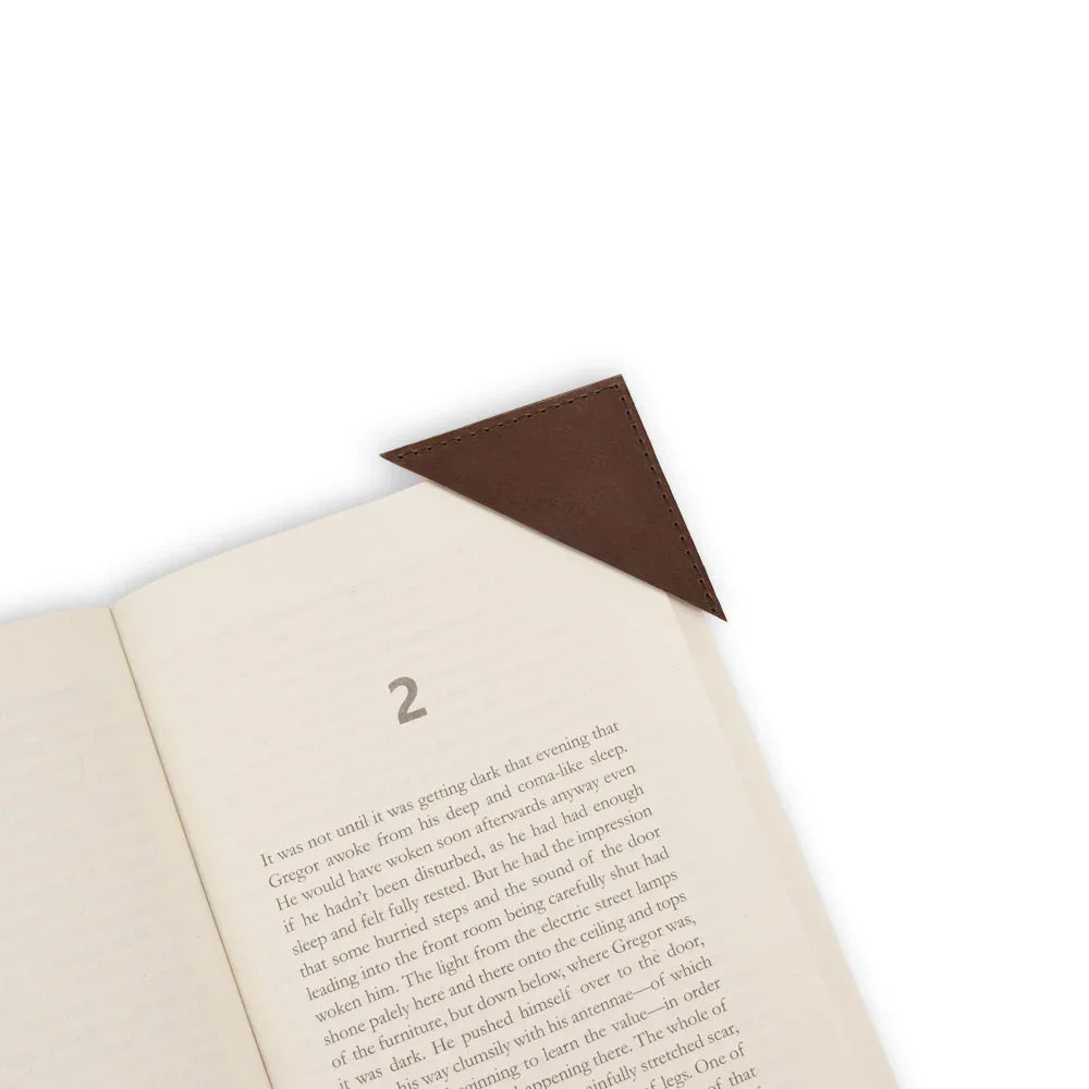 Open book with a brown leather corner bookmark on a white background