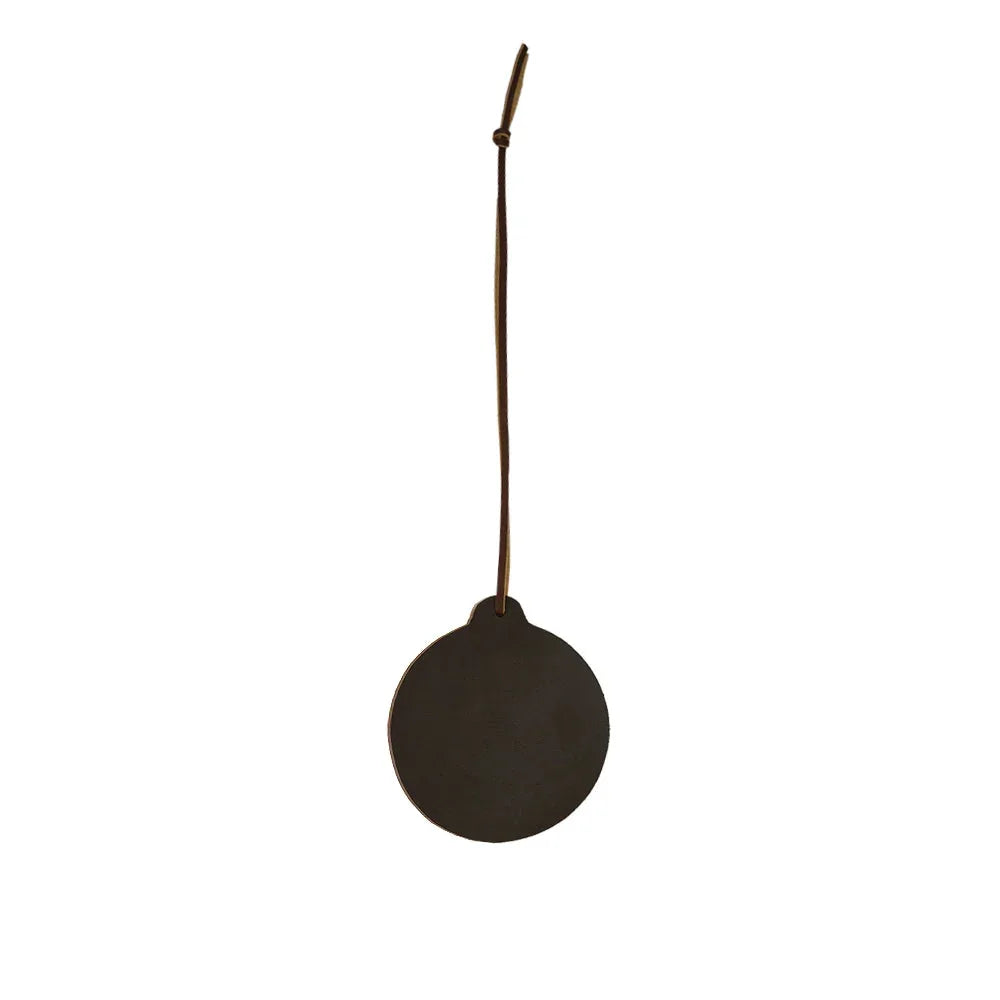 Round dark object with a string on a white background