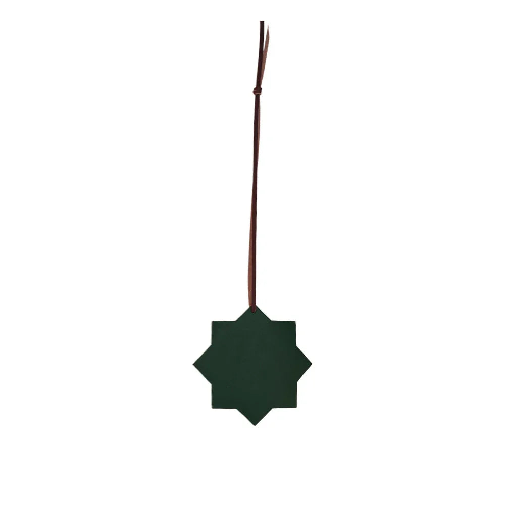 Green star-shaped ornament on a white background