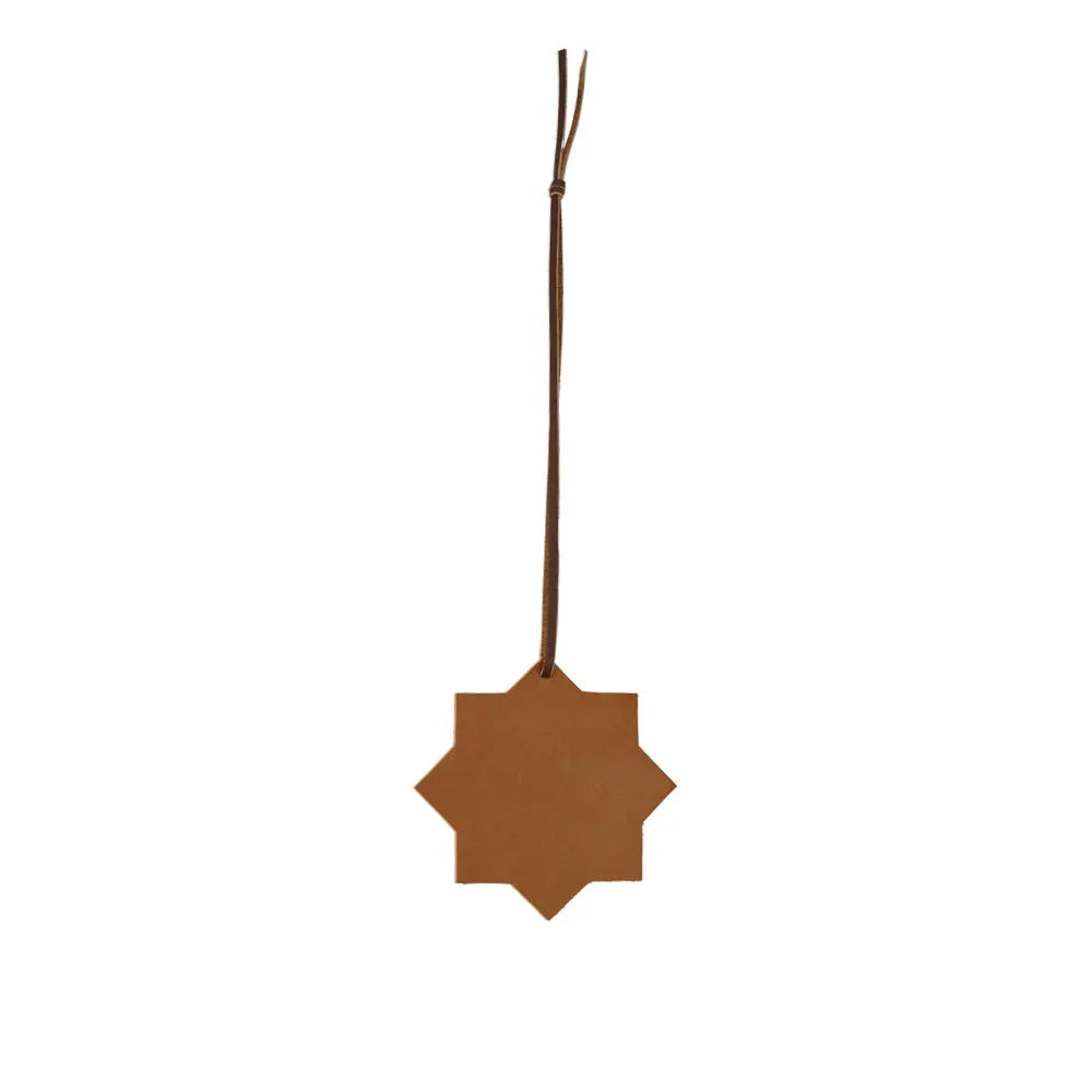 Brown star-shaped ornament hanging on a white background