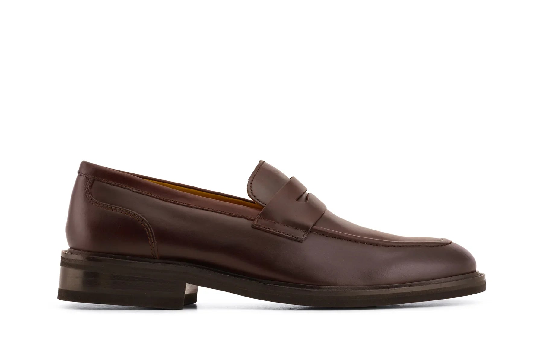 Men's brown leather penny loafer dress shoe with low stacked heel on white background