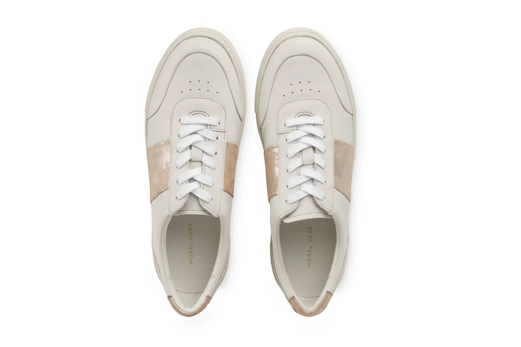 Pair of white leather sneakers with beige accents and white laces, viewed from above