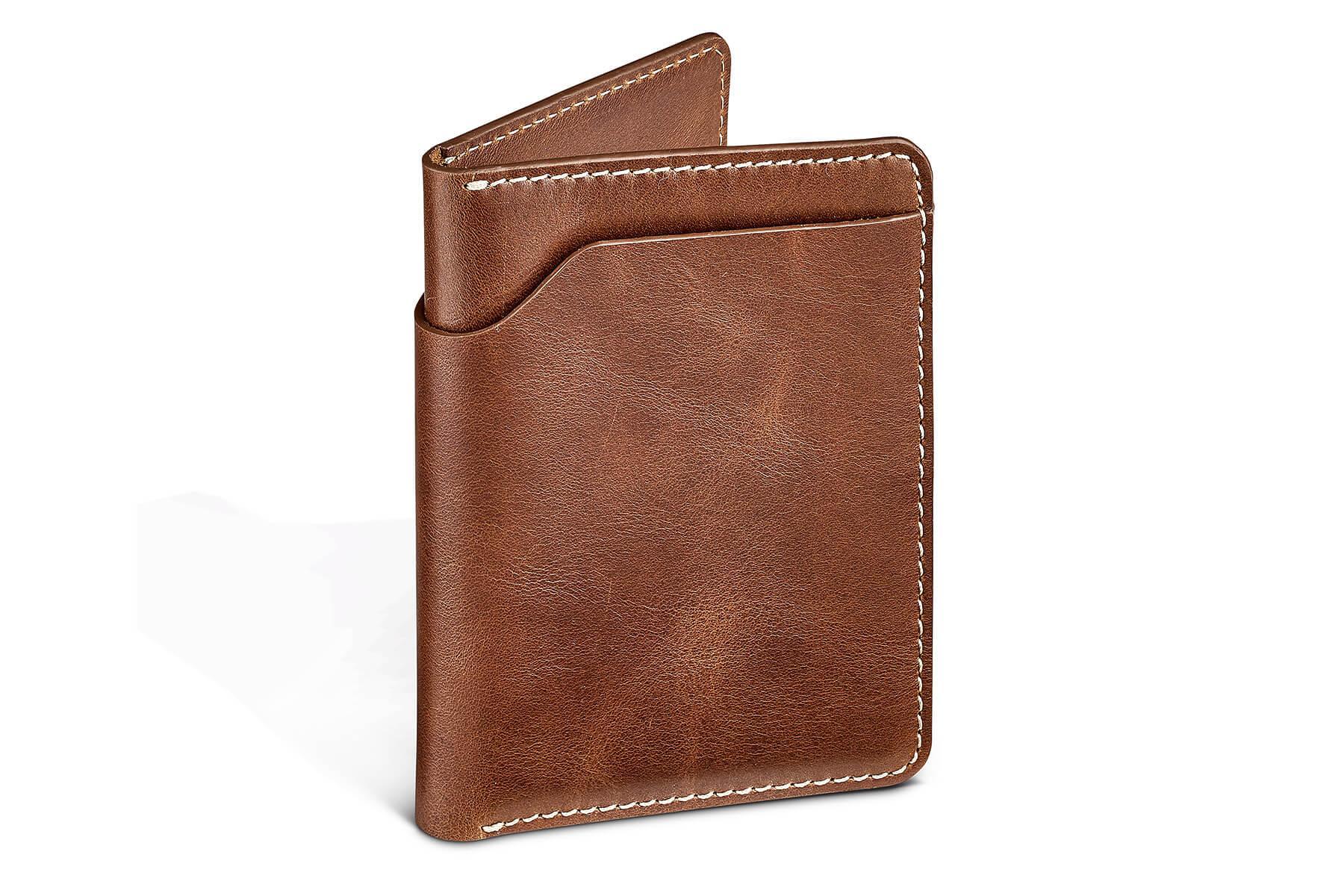 Brown leather bifold wallet with white stitching, minimalist accessory on white background