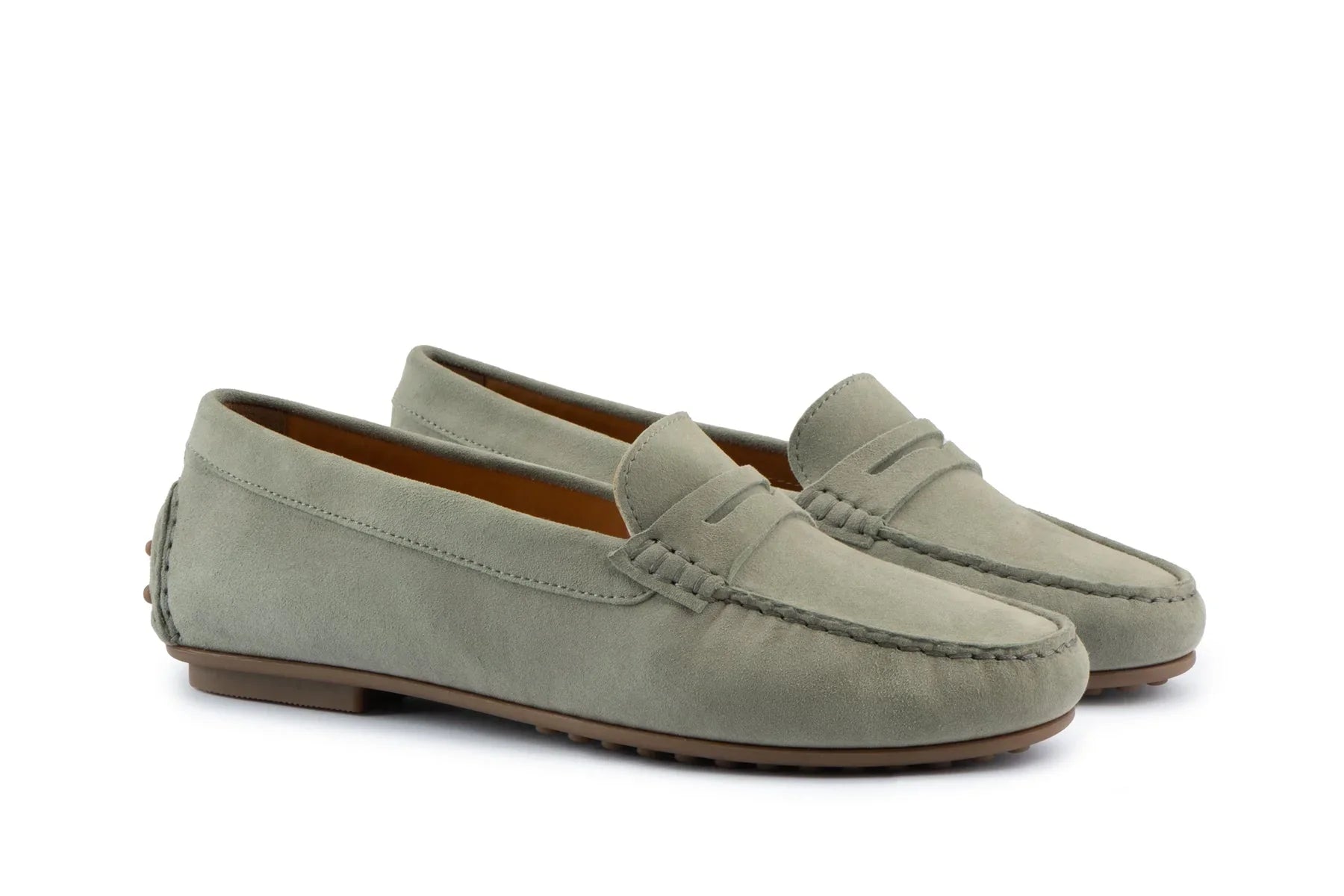 Pair of olive green suede penny loafers with moccasin stitching and rubber soles