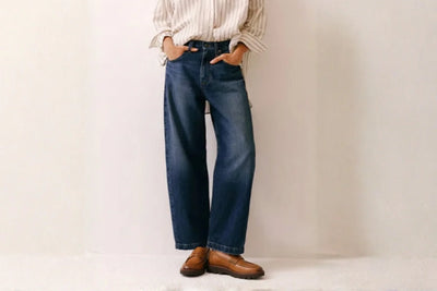 Brown leather loafers with chunky sole styled with blue jeans and striped shirt 