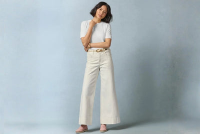 Woman wearing white wide-leg pants, short sleeve top, and pink leather loafers 