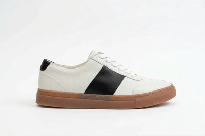 White leather sneaker with black stripe and heel accent, gum sole, on white background 