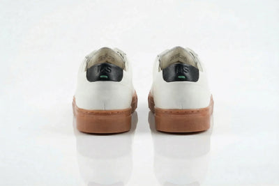 Back view of white leather sneakers with tan soles and black heel tab, on white background 