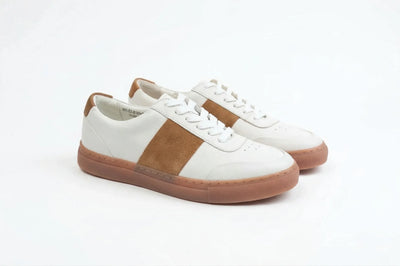 White leather sneakers with brown suede stripe and gum sole on white background 