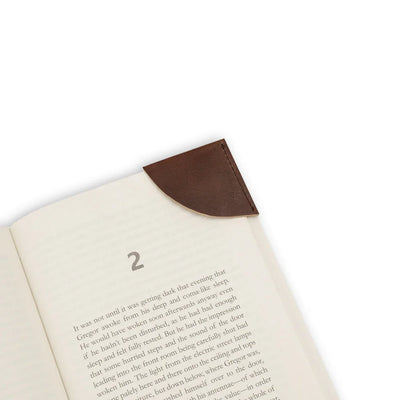 Open book with a leather bookmark on a white background