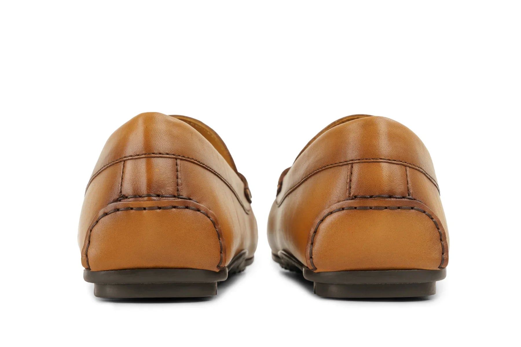 Back view of tan leather loafers with visible stitching on white background 