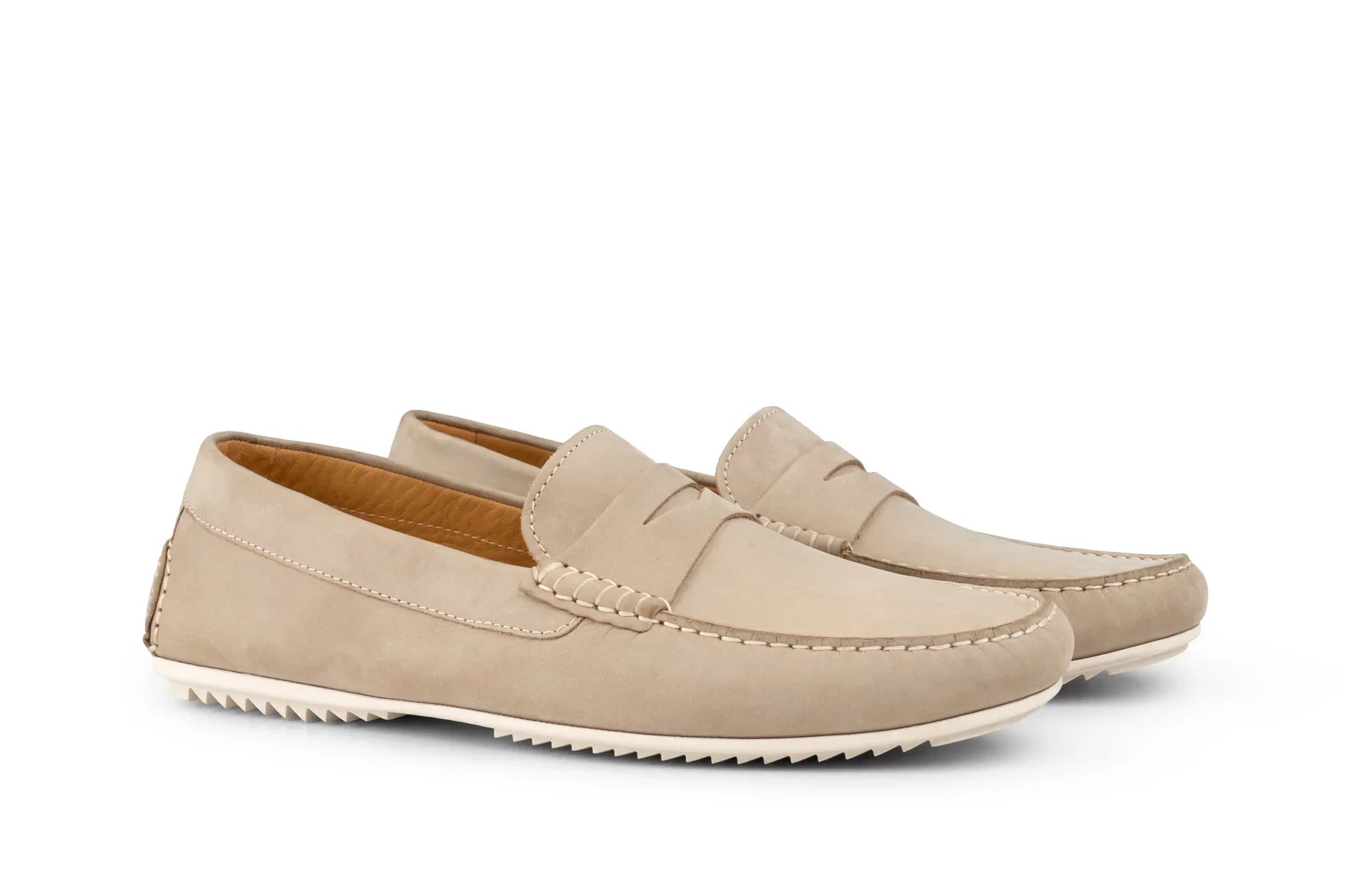 Men's beige suede penny loafers with white rubber soles on white background 