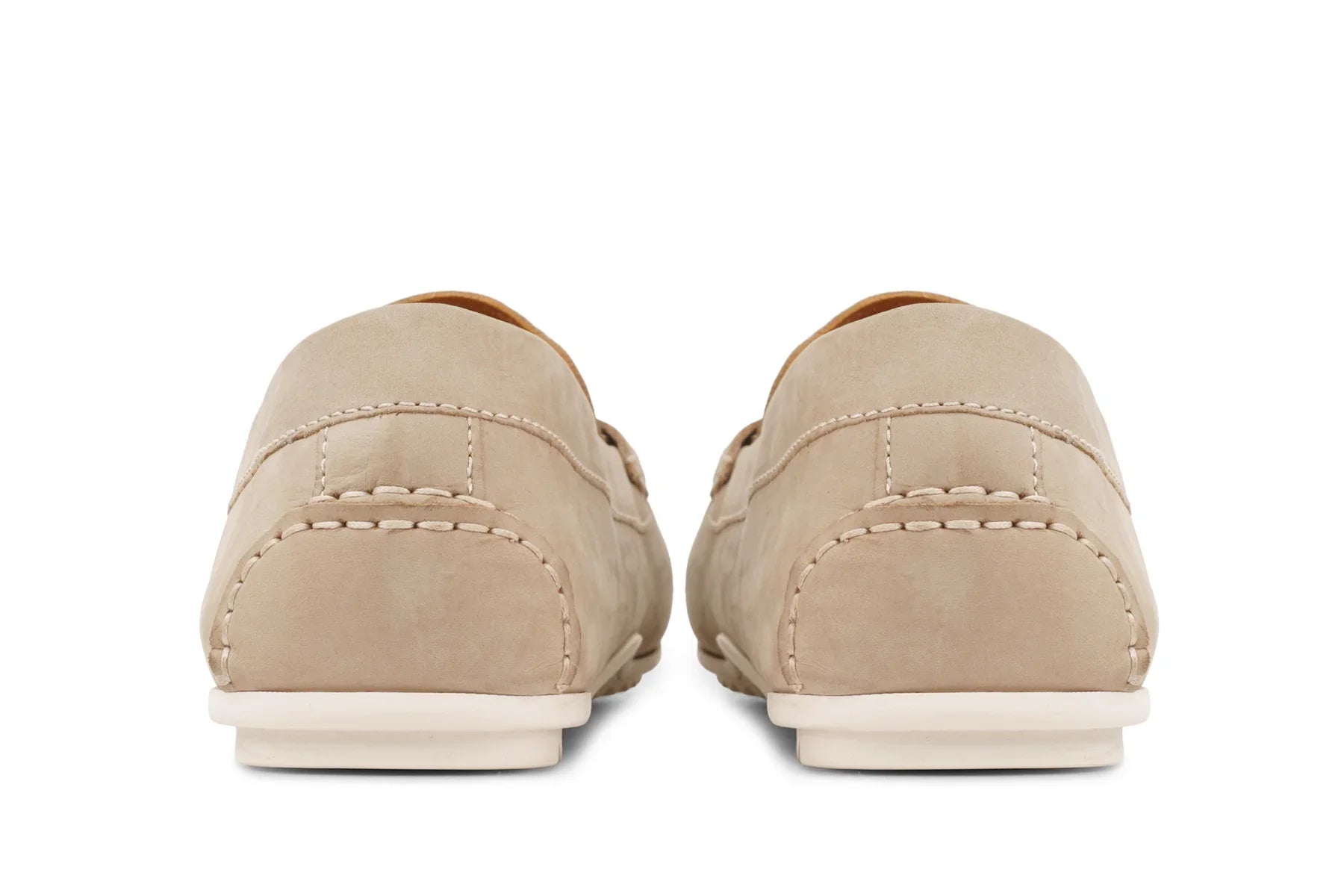 Back view of beige leather loafers with visible stitching and white soles 