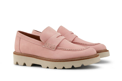 Pair of pink leather loafers with chunky beige rubber soles on white background 
