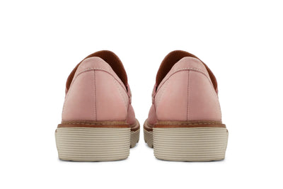 Back view of pink leather loafers with beige ribbed soles on white background 