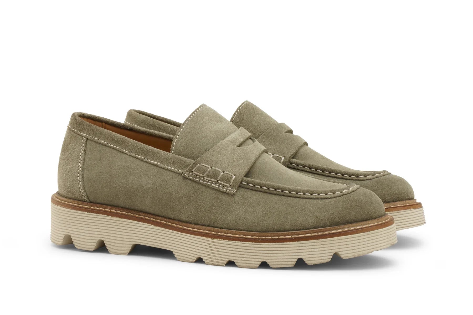Men's light olive suede loafers with lugged sole and contrast stitching on white background 