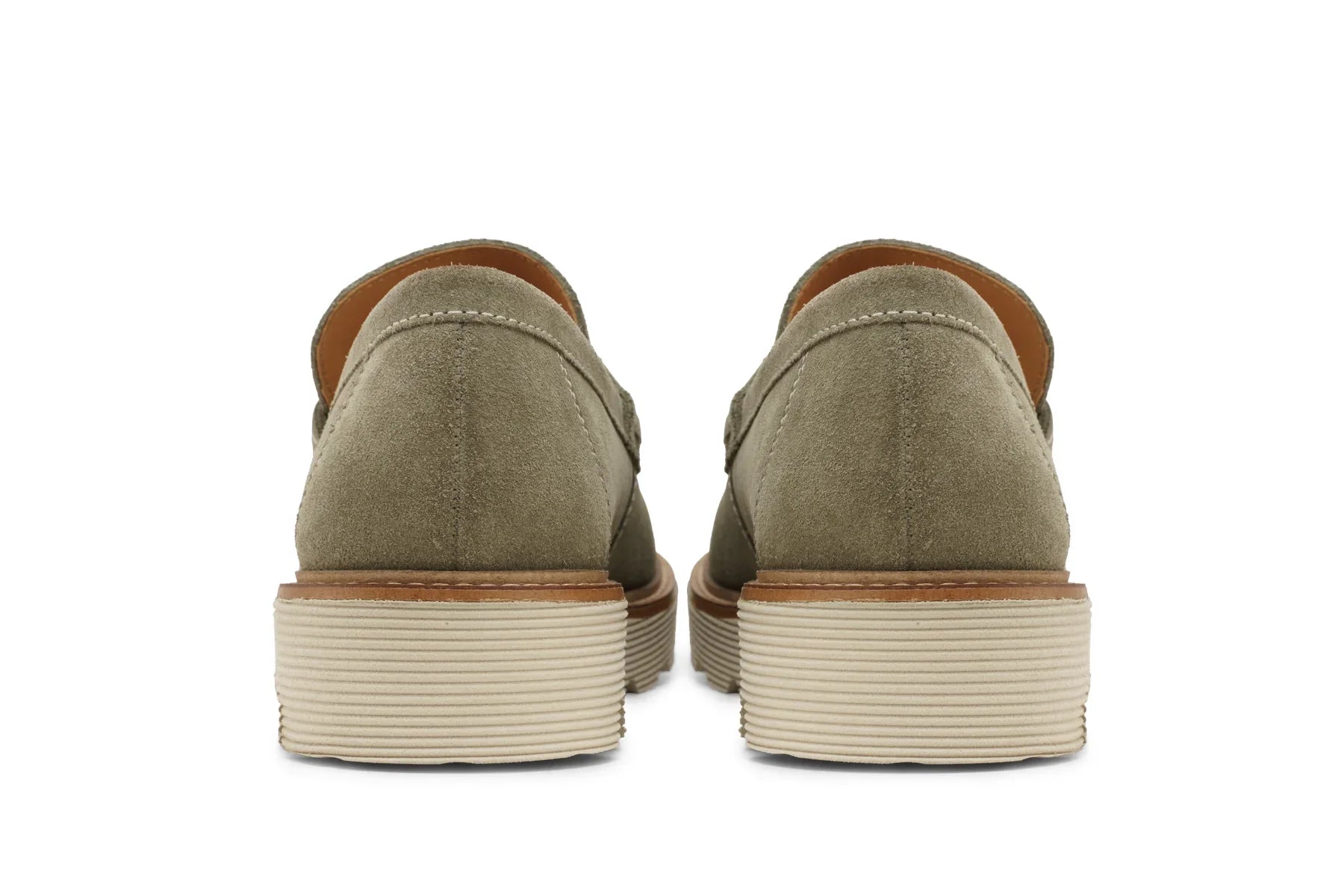 Back view of light olive suede leather loafers with stacked rubber soles on white background  