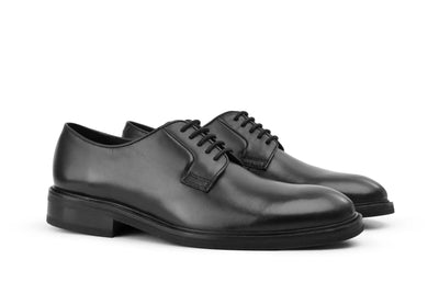 Black leather dress shoes with lace-up design, classic men's formal footwear on white background   
