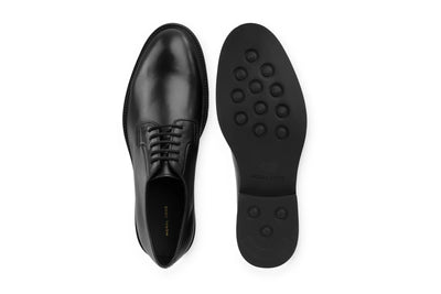 Black leather derby dress shoe with rubber sole, shown from top and bottom views 