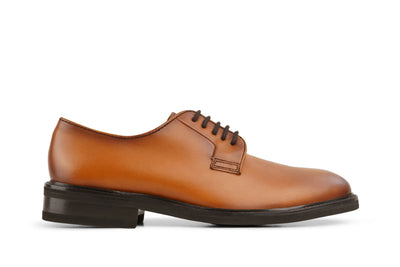Classic cognac brown leather derby dress shoe with dark sole and laces on a white background  