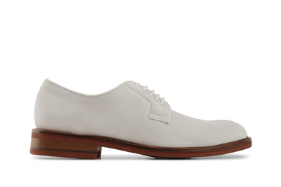 Ivory suede men's derby shoe with brown stacked sole on white background  