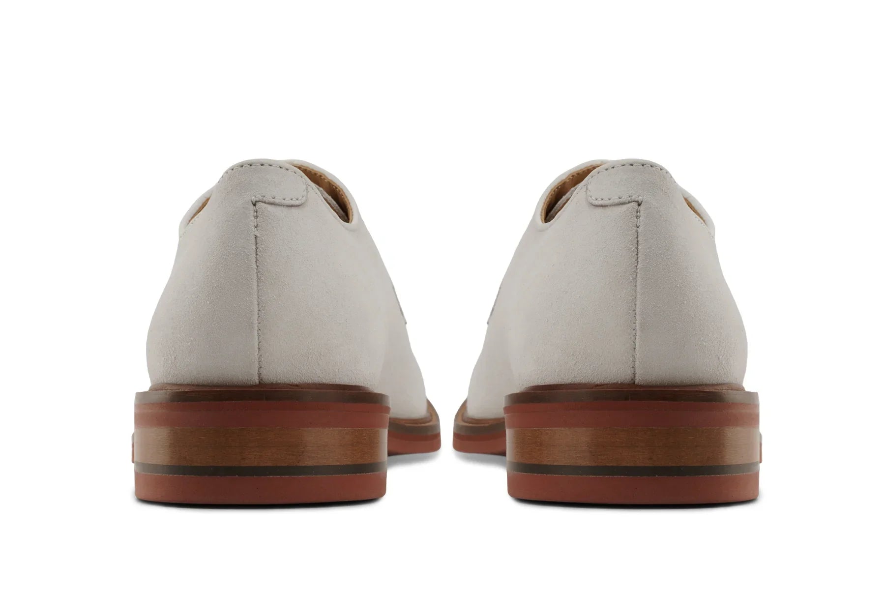 Back view of ivory leather derby shoes with stacked wooden soles on white background 