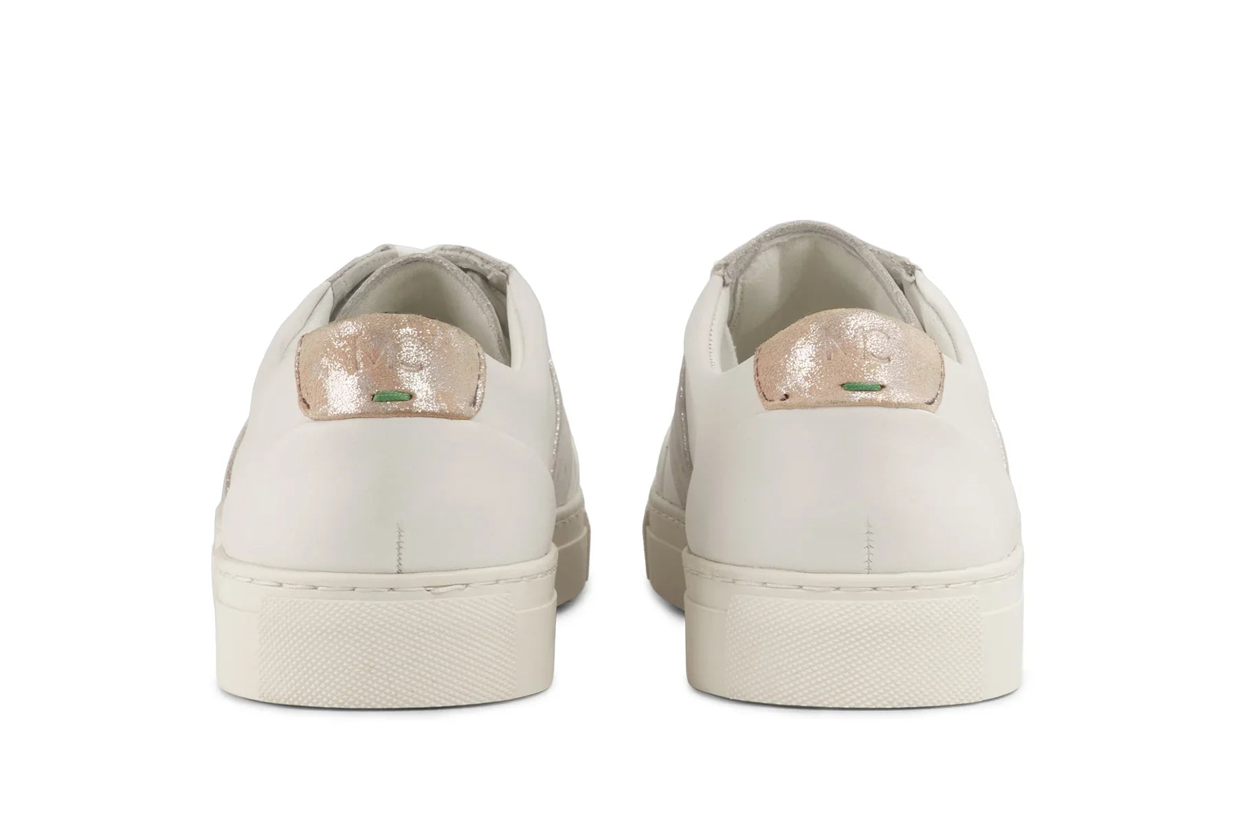 Back view of white leather sneakers with metallic champagne accents and green detail on heel tabs 