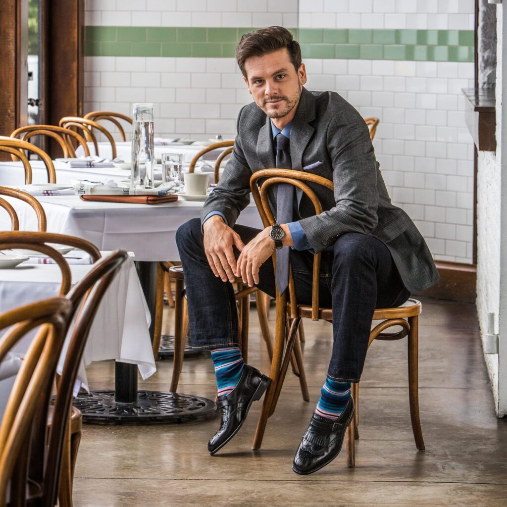 Man Sitting in Chair Wearing Black Jeans